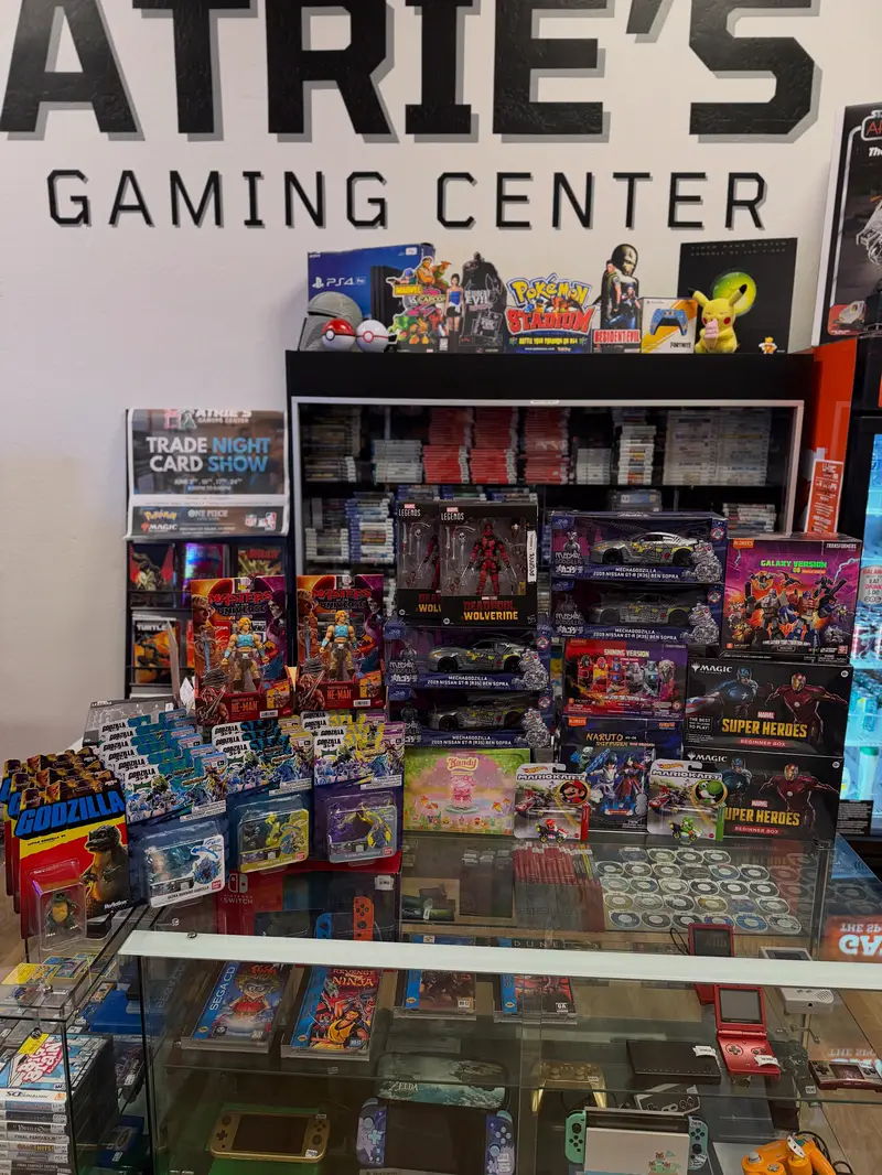 Pokémon boxes and trading cards stacked behind the glass counter
