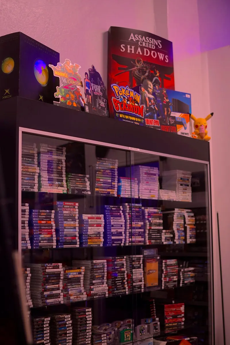 A glass case stacked with used PlayStation, Xbox and Nintendo games
